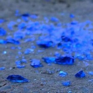 Shards of blue glass scattered on a nondescript gray ground.